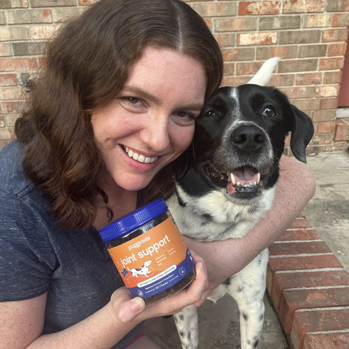 Women and and her dog with a jar of joint support chews.