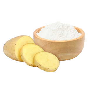 Potato slices and a wooden bowl of white starch powder.