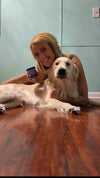 Woman with golden retriever holding PupGrade supplement.